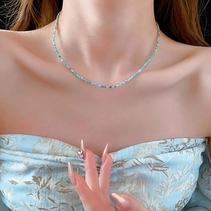 Close-up of minimalist light blue amazonite beaded necklace with silver cylindrical beads