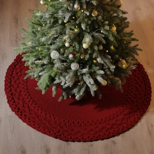 48 inch red knitted Christmas tree skirt with festive diamond pattern on wood floor