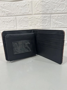 Detailed interior view of a short black wallet with card slots and a snap coin pocket