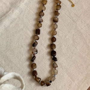 Vintage irregular agate beaded titanium necklace with natural stones on linen background
