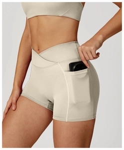 Detail showing high-waisted yoga shorts with V-shaped cross waist and side phone pocket