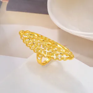 Macro view of gold plated filigree ring with hollow floral patterns and star engraving