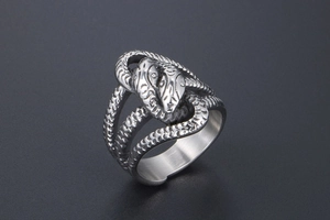 Macro shot of double-headed snake ring showing detailed scales and brushed steel texture