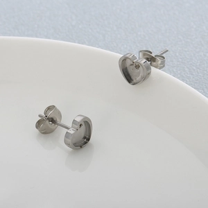 Detailed macro view of heart-shaped 316L stainless steel stud earring bases in silver
