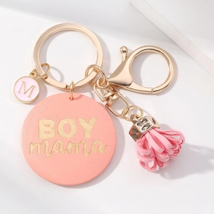 Pink BOY MAMA leather keychain with gold tassel and letter M charm on white background