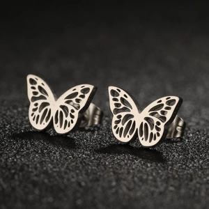Macro shot of silver hollow butterfly stud earrings showing intricate wing details