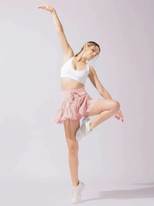 Detail of pink layered high-waisted pleated athletic skort with ruffle design for women