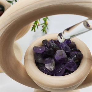 Macro shot of essential oil diffuser with natural wood ring and raw purple amethyst stones