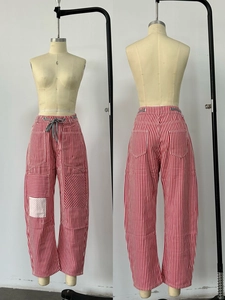 Detail of red and white striped wide-leg pants with drawstring waist and cargo pockets