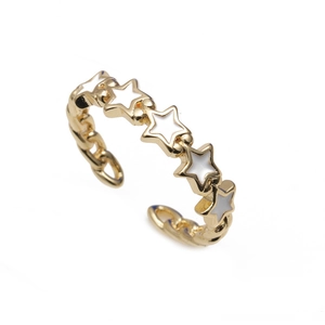 Macro view of 18K gold star ring featuring white enamel inlays and a polished finish