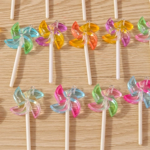 Macro detail of colorful gradient resin windmill lollipop charms with glitter finish