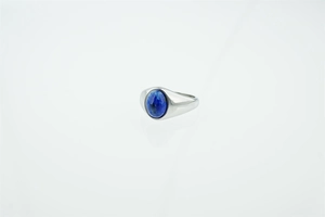 Detailed close-up of a silver signet ring featuring a polished oval blue turquoise stone