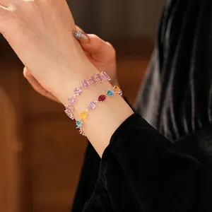Elegant multi-color oval zircon bracelets in silver-tone finish on a model's wrist