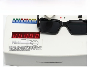 Technical testing of black square sunglasses showing UV400 protection on a UV detector device