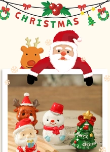 Detail of Christmas resin figurines featuring Santa, snowman, reindeer and a mini tree