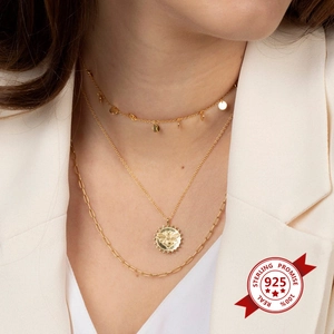 Three-layer gold S925 sterling silver necklace with coin bee pendant on white blazer