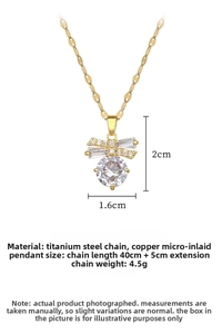 Detailed view of butterfly pendant set with sparkling zircon and gold titanium steel chain
