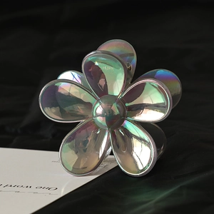 Macro detail of holographic flower hair claw clip with colorful resin petals and sturdy grip