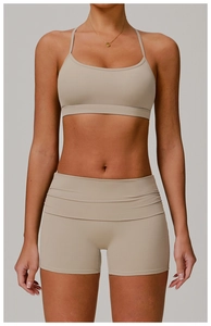 Close-up of nude high-waisted fitness shorts and sports bra set in seamless fabric