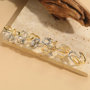 Minimalist two-tone geometric open rings set with polished gold and silver finish