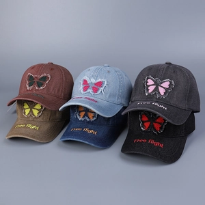 Close-up of vintage denim baseball caps with bow embroidery and Free Flight brim text