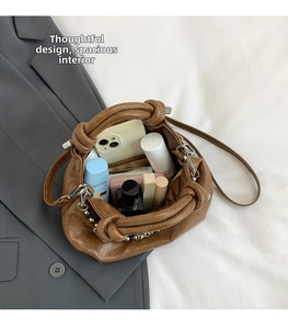 Detail view of large storage capacity for brown leather cloud bag with knotted handle