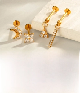 Detailed close-up of titanium alloy piercing jewelry set with cubic zirconia stones
