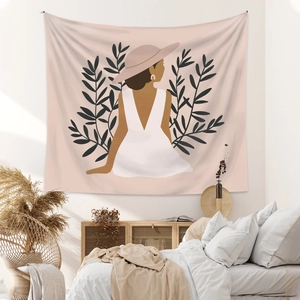 Detailed close-up of a bohemian wall tapestry featuring minimalist female line art in a bedroom