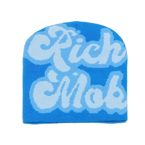 Detailed knit texture of blue beanie featuring bold white Rich Mob artistic embroidery