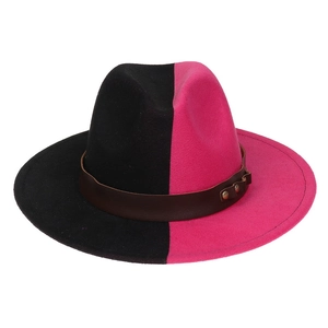 Detail view of pink and black wool felt fedora with brown leather band and metal studs