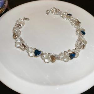 Detailed close-up of crystal beaded necklace with blue and champagne heart-shaped gems