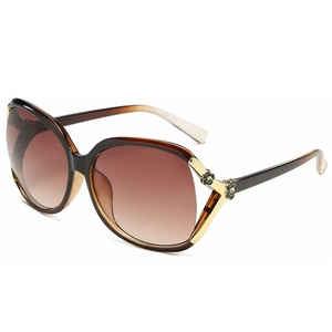 Polarized camellia sunglasses for women featuring oversized brown gradient lenses and gold frames