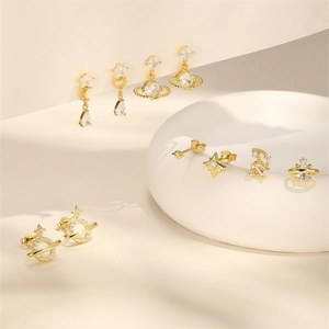 Detailed set of S925 silver celestial earrings featuring gold stars and Saturn rings