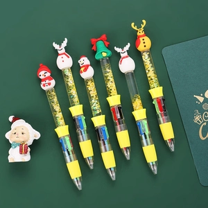 Macro detail of Christmas multi-color pens with quicksand glitter and cartoon toppers