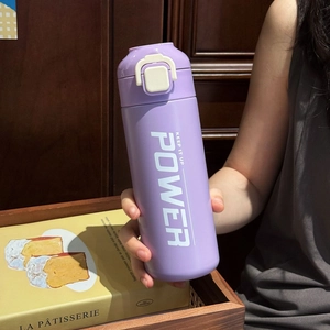 Close-up of portable purple stainless steel sports bottle with white push-button lid