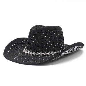 Detail of black cowboy hat featuring sparkling silver rhinestones and a floral crystal band