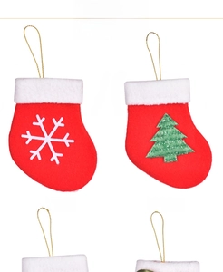 Detail of mini Christmas stockings featuring white snowflake and green tree designs