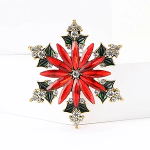 Christmas snowflake brooch with red marquise rhinestones and green enamel leaves