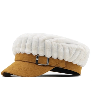 Detail view of plush white faux fur newsboy cap with camel suede brim and metal buckle