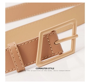 Close-up of khaki leather belt with golden square buckle and fine stitching details
