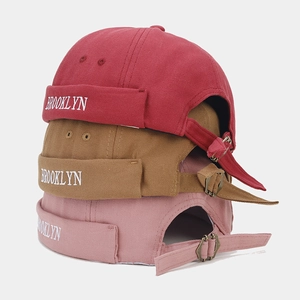 Vertical stack of Brooklyn embroidered docker hats with adjustable metal buckle detail