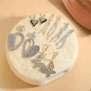 Silver and gold drop earrings set with crystals featuring heart, butterfly and tassel designs