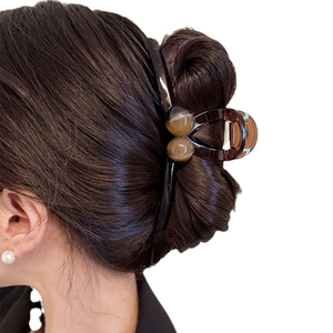 Brown tortoiseshell acrylic round claw clip for women hair styling on white background