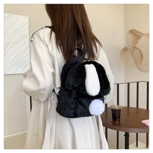 Detailed view of the cute black and white plush bunny ears backpack on a model