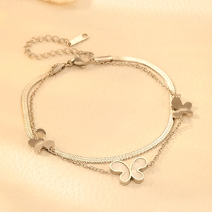 Detail of silver double-layer butterfly bracelet with shell inlay on snakeskin chain