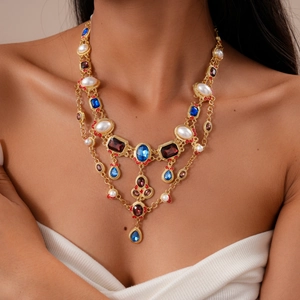 Detail of vintage multi-layer necklace with colorful rhinestones and faux pearls