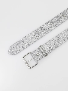 Detailed view of silver sequin belt with rhinestone buckle and metallic eyelets in Y2K style