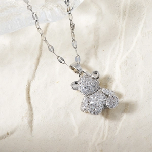 Macro detail of silver bear necklace showing S925 stamp and micro-pave crystals