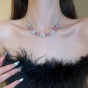 Detail of necklace with pink square crystals and clear round zircon accents on model