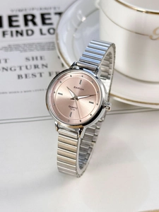 Detail of elegant silver chain watch featuring a rose gold dial and luxury quartz movement